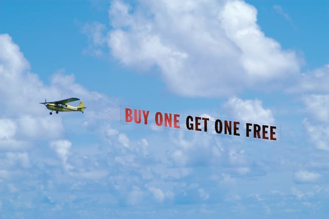 A banner tow pilot with an advertisement reading "Buy One Get One Free"